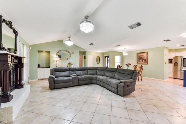 living area with lofted ceiling, light tile patterned flooring, visible vents, and baseboards
