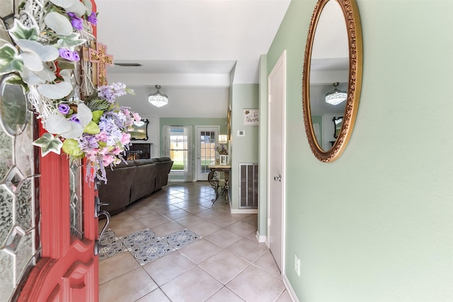 entryway featuring baseboards, visible vents, and light tile patterned floors