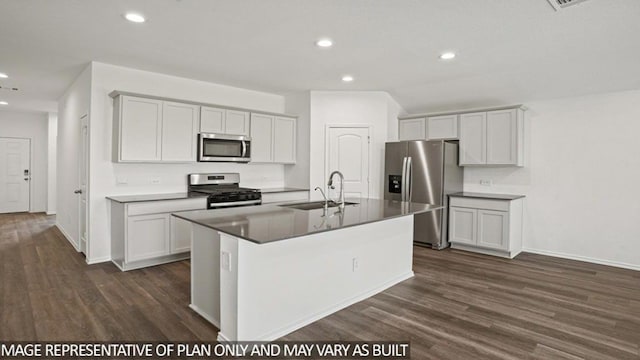 kitchen with dark wood-style flooring, appliances with stainless steel finishes, a sink, and recessed lighting
