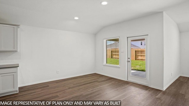 interior space with recessed lighting, lofted ceiling, baseboards, and dark wood-style flooring