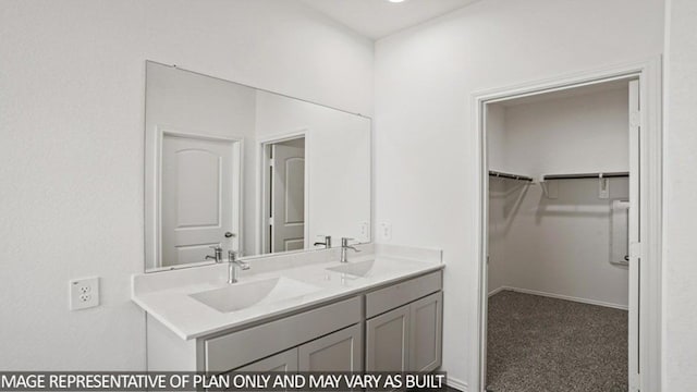 full bathroom with a spacious closet, a sink, and double vanity