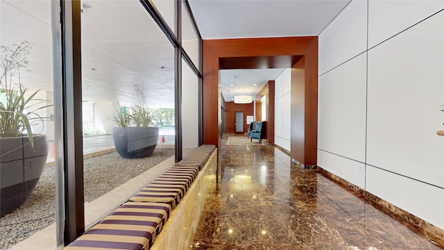 hall featuring marble finish floor