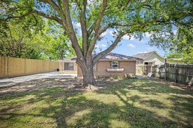 view of yard with a fenced backyard and a patio