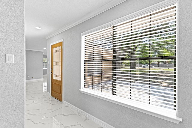 hall featuring marble finish floor, a textured wall, baseboards, ornamental molding, and recessed lighting