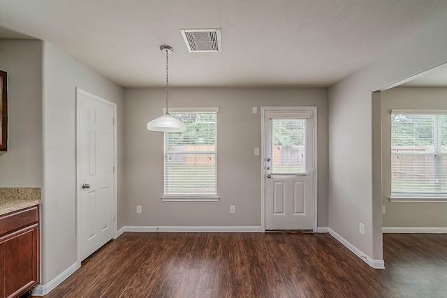 21423 Palma Grove Way, Houston, TX 77073 - unfurnished dining area with baseboards, dark wood-style flooring, visible vents, and a healthy amount of sunlight