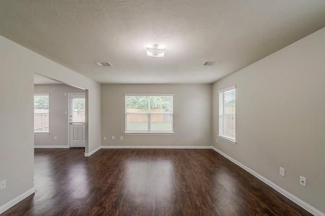 21423 Palma Grove Way, Houston, TX 77073 - unfurnished room featuring visible vents, baseboards, and dark wood-style floors