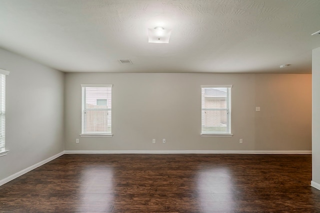 21423 Palma Grove Way, Houston, TX 77073 - spare room with baseboards, a healthy amount of sunlight, and dark wood-style floors