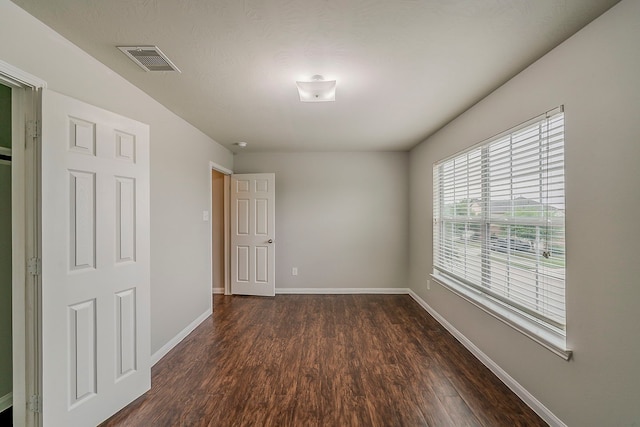21423 Palma Grove Way, Houston, TX 77073 - unfurnished room with baseboards, dark wood-style flooring, and visible vents