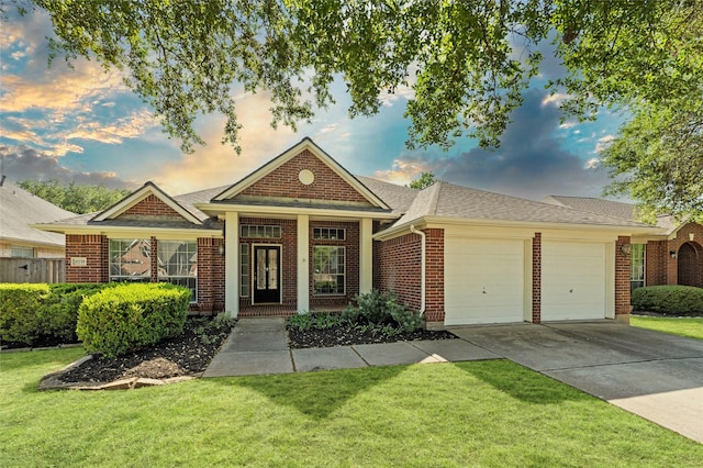 single story home featuring a front lawn, roof with shingles, concrete driveway, brick siding, and a garage