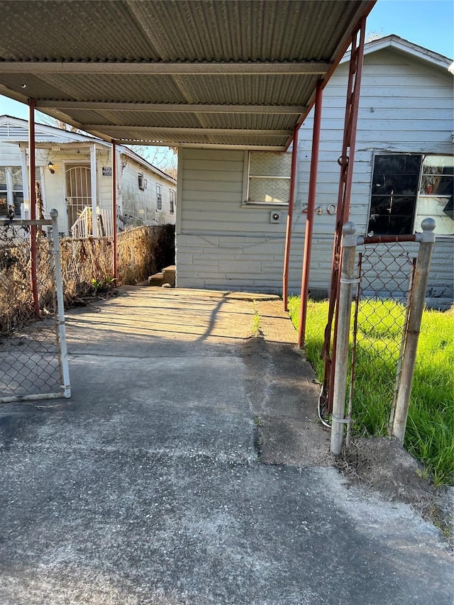 2406 Delano St, Houston, TX 77004 - view of parking / parking lot featuring fence and an attached carport