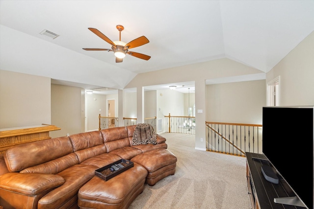 living room with visible vents, vaulted ceiling, carpet flooring, and a ceiling fan