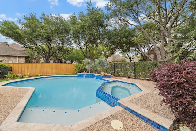 view of pool with a fenced backyard and a pool with connected hot tub