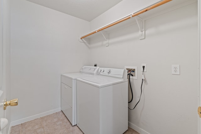 laundry area featuring baseboards, laundry area, and independent washer and dryer