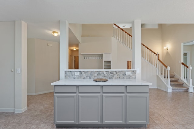 kitchen with gray cabinets, light tile patterned floors, and light countertops