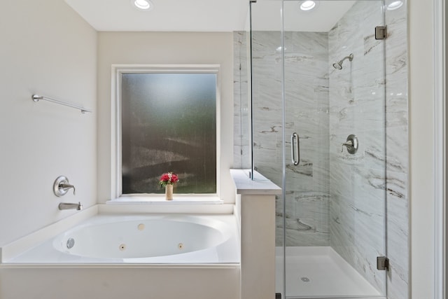bathroom with recessed lighting, a shower stall, and a jetted tub