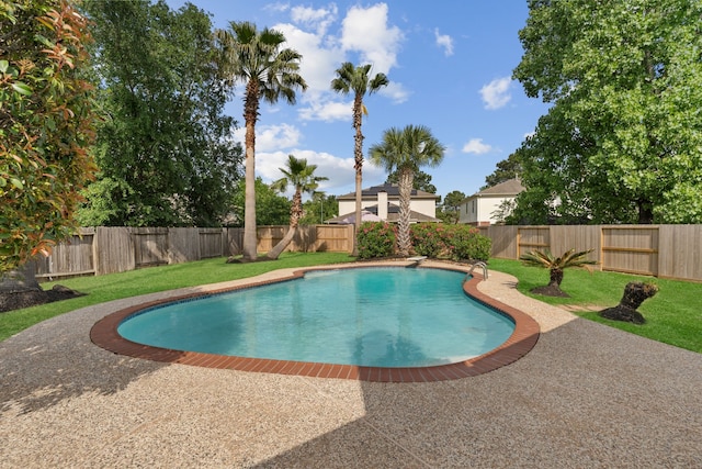 view of pool featuring a patio area, a fenced in pool, a lawn, and a fenced backyard