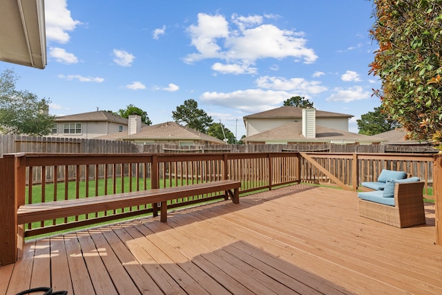 wooden deck featuring a fenced backyard