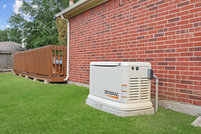 details featuring brick siding, fence, and a power unit