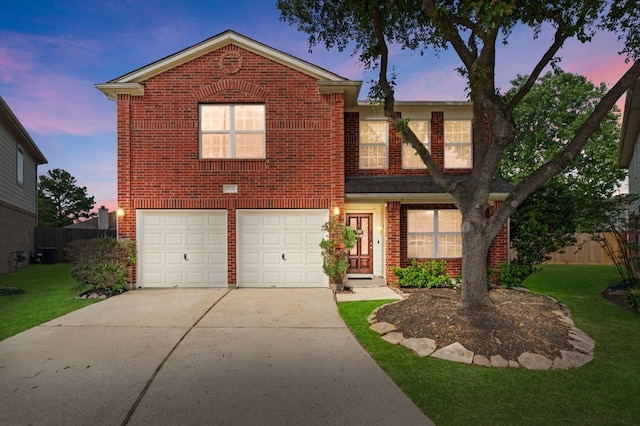 traditional-style house featuring brick siding, a front lawn, concrete driveway, and fence