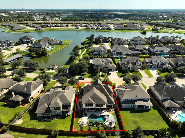 aerial view featuring a residential view and a water view