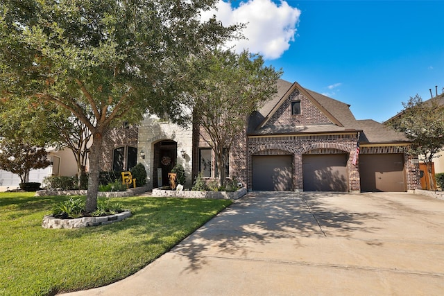view of front of property featuring an attached garage, a front lawn, driveway, and brick siding