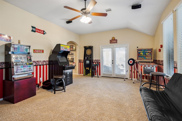 carpeted office space with vaulted ceiling, visible vents, ceiling fan, and a healthy amount of sunlight
