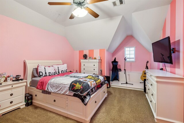 bedroom with light colored carpet, vaulted ceiling, a ceiling fan, and visible vents