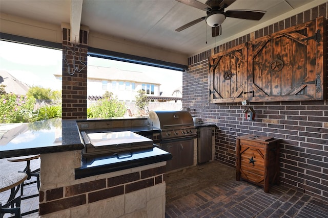 view of patio / terrace with exterior kitchen, outdoor wet bar, area for grilling, and a ceiling fan