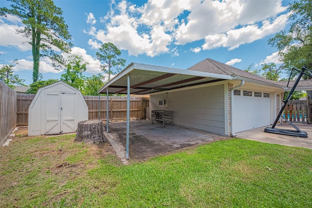rear view of property with a storage shed, an attached garage, an outdoor structure, and a shingled roof