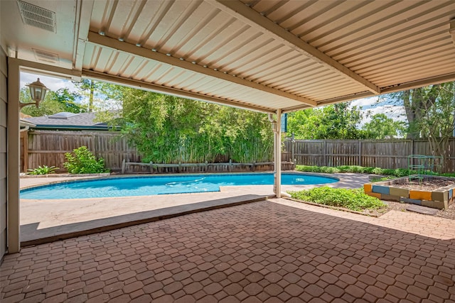view of swimming pool featuring a patio area and a fenced backyard