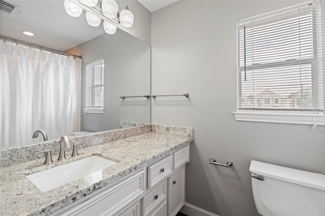 bathroom featuring toilet, baseboards, visible vents, curtained shower, and vanity