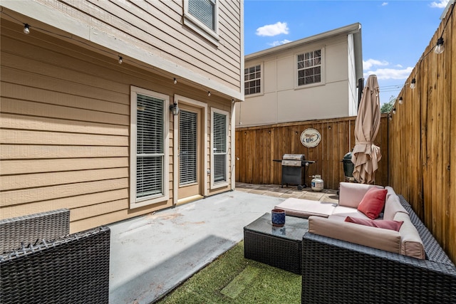 view of patio with a grill, fence, and an outdoor hangout area