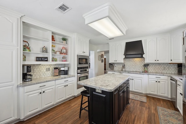 310 Yorkshire Ln, Port Neches, TX 77651 - kitchen with visible vents, custom exhaust hood, decorative backsplash, open shelves, and appliances with stainless steel finishes