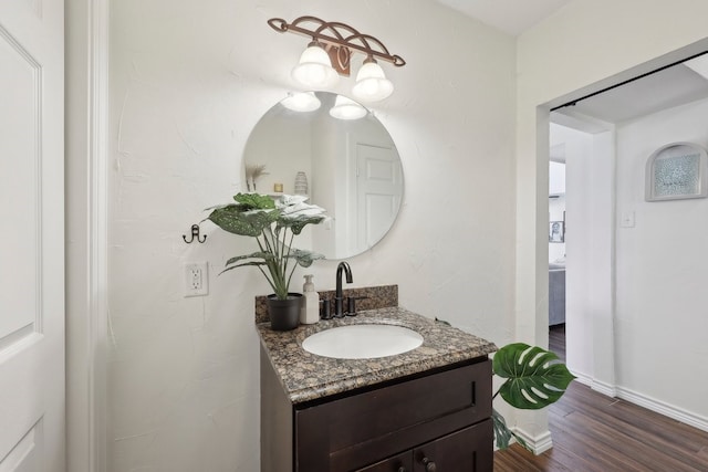 310 Yorkshire Ln, Port Neches, TX 77651 - bathroom featuring baseboards, vanity, and wood finished floors