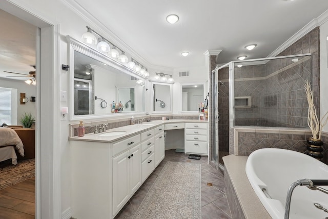 310 Yorkshire Ln, Port Neches, TX 77651 - bathroom with a shower stall, a ceiling fan, a sink, a bath, and visible vents
