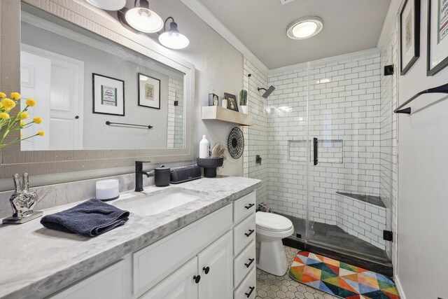 310 Yorkshire Ln, Port Neches, TX 77651 - bathroom with a shower stall, tile patterned floors, toilet, vanity, and crown molding