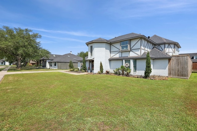 310 Yorkshire Ln, Port Neches, TX 77651 - view of front of home featuring a front lawn, driveway, and brick siding