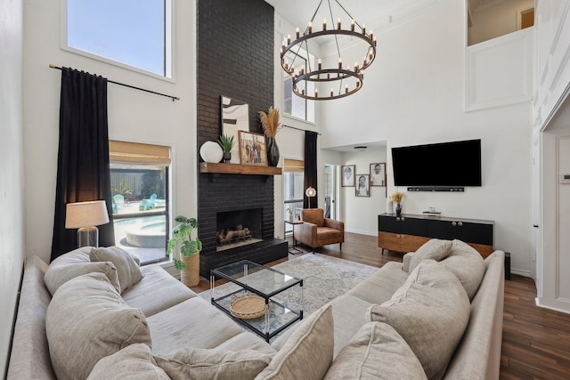 310 Yorkshire Ln, Port Neches, TX 77651 - living area featuring a brick fireplace, wood finished floors, a healthy amount of sunlight, and a towering ceiling