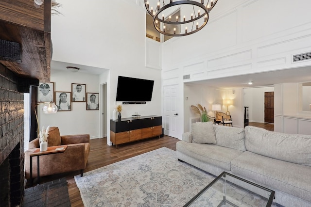 310 Yorkshire Ln, Port Neches, TX 77651 - living area featuring an inviting chandelier, visible vents, a high ceiling, and dark wood-style flooring