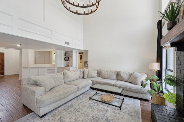 310 Yorkshire Ln, Port Neches, TX 77651 - living area featuring visible vents, a high ceiling, a notable chandelier, and dark wood finished floors