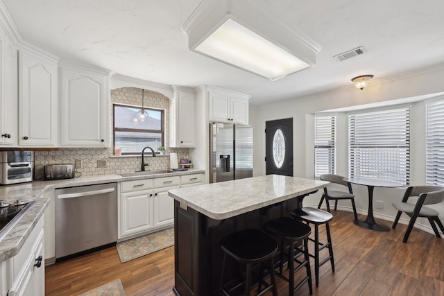 310 Yorkshire Ln, Port Neches, TX 77651 - kitchen with a wealth of natural light, stainless steel appliances, dark wood-type flooring, and a sink