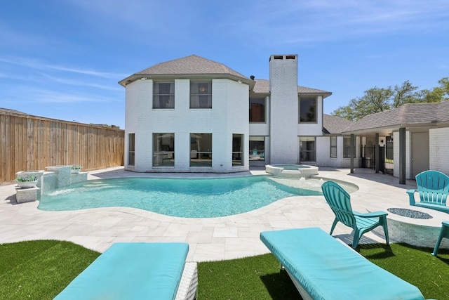 310 Yorkshire Ln, Port Neches, TX 77651 - view of swimming pool with a fenced backyard, a fire pit, a pool with connected hot tub, and a patio