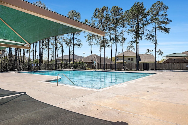 pool with fence and a patio