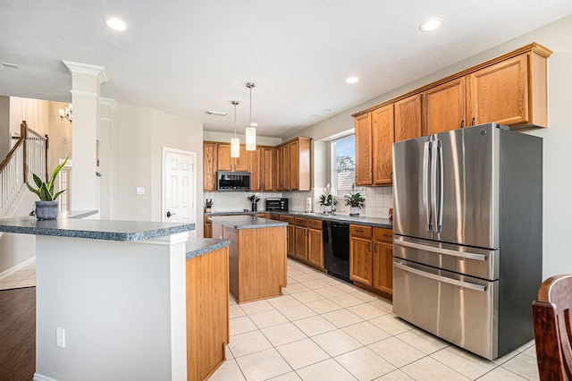 kitchen featuring tasteful backsplash, freestanding refrigerator, a kitchen island, dishwasher, and a sink