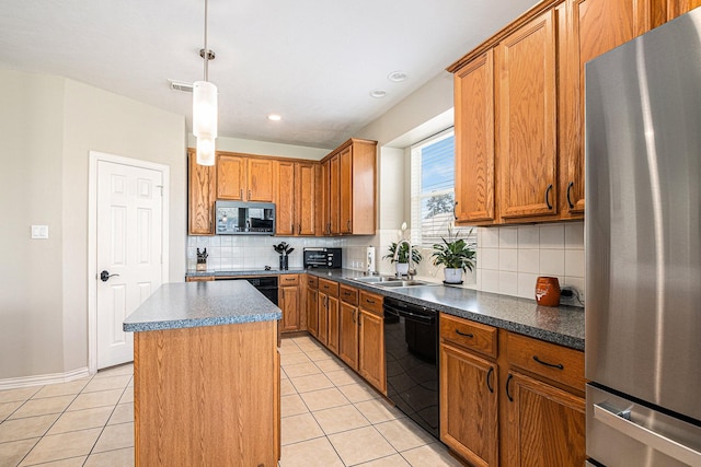 kitchen featuring a sink, decorative backsplash, dishwasher, freestanding refrigerator, and a kitchen island