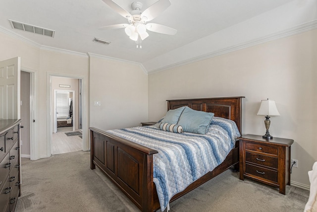 bedroom featuring crown molding, light colored carpet, vaulted ceiling, and visible vents