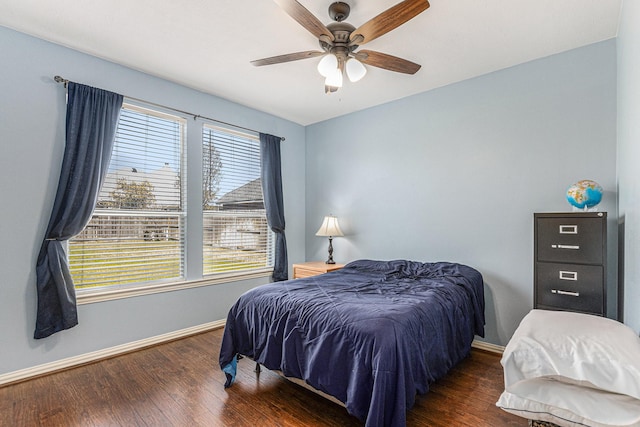 bedroom with baseboards, a ceiling fan, and wood finished floors