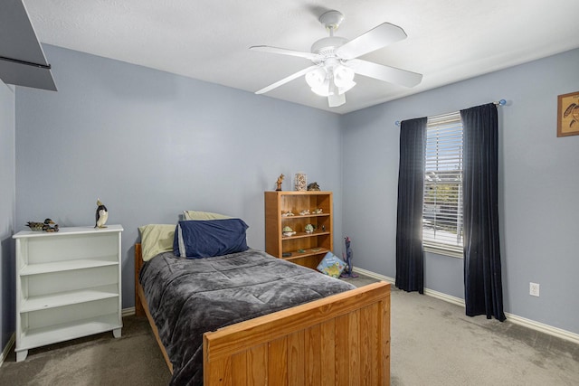 bedroom featuring ceiling fan, carpet flooring, and baseboards