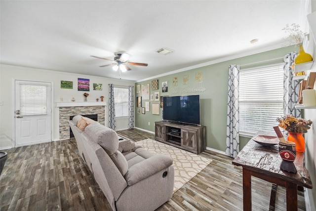 38 Wineberry Pl, The Woodlands, TX 77382 - living area with ceiling fan, ornamental molding, wood finished floors, baseboards, and a stone fireplace