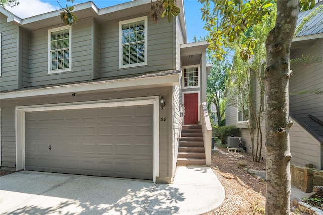 38 Wineberry Pl, The Woodlands, TX 77382 - view of front of house featuring a garage, central air condition unit, and entry steps